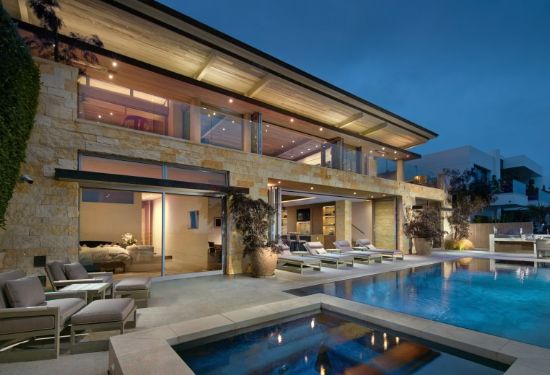 Glass doors open onto the terrace with its infinity-edge pool, raised spa and outdoor kitchen. (Photo by Toby Ponnay)